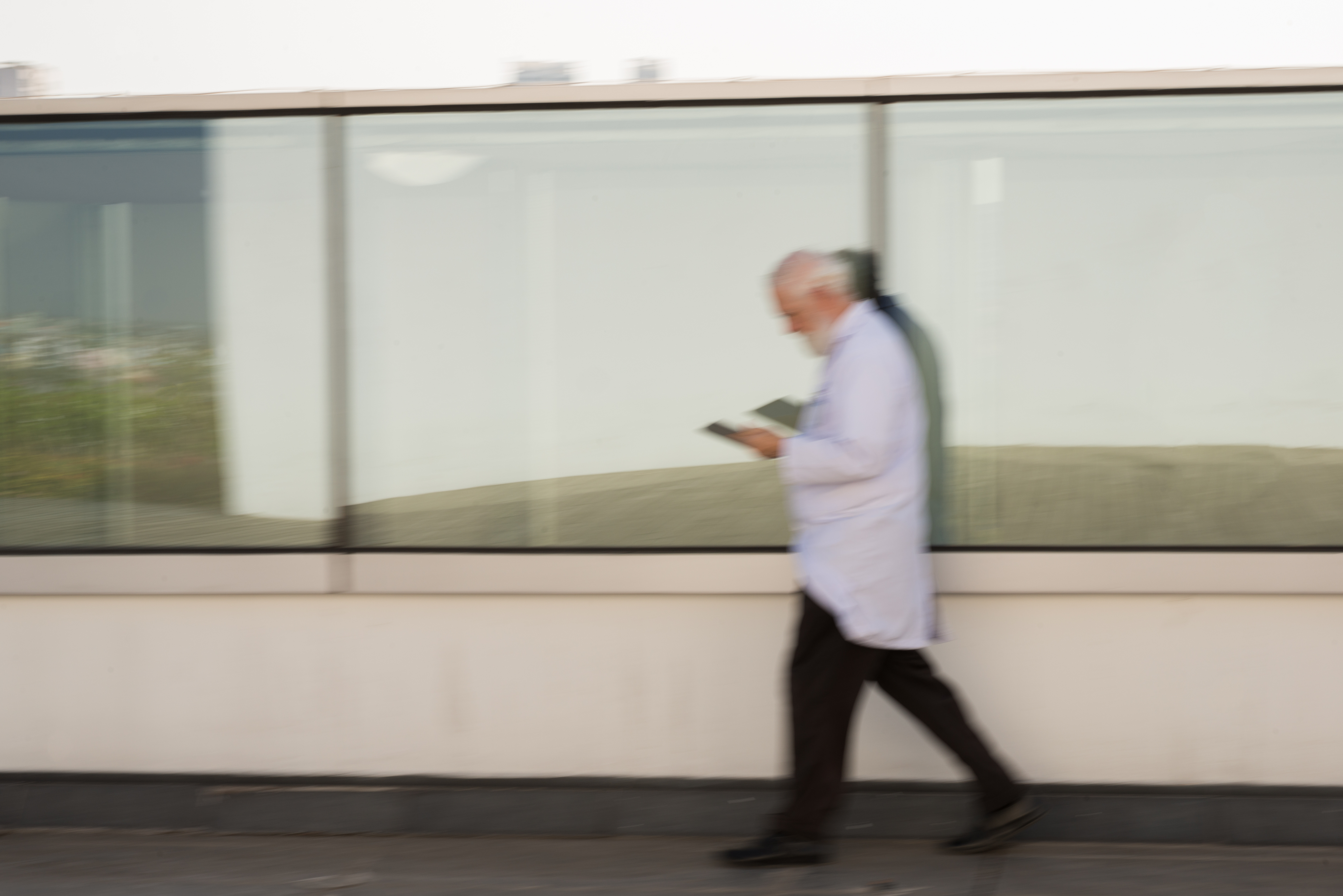 Woman with sunglasses walking down runway